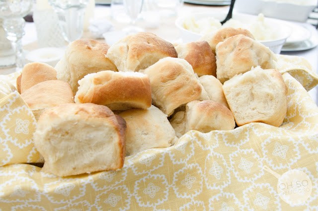 basket of rolls laying on a printed cloth 
