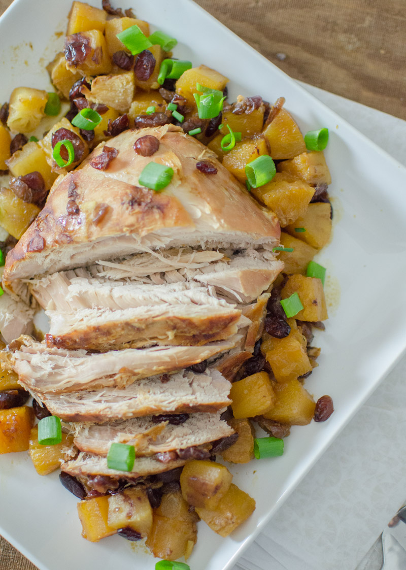 pork roast in dish surrounded by pineapple chunks