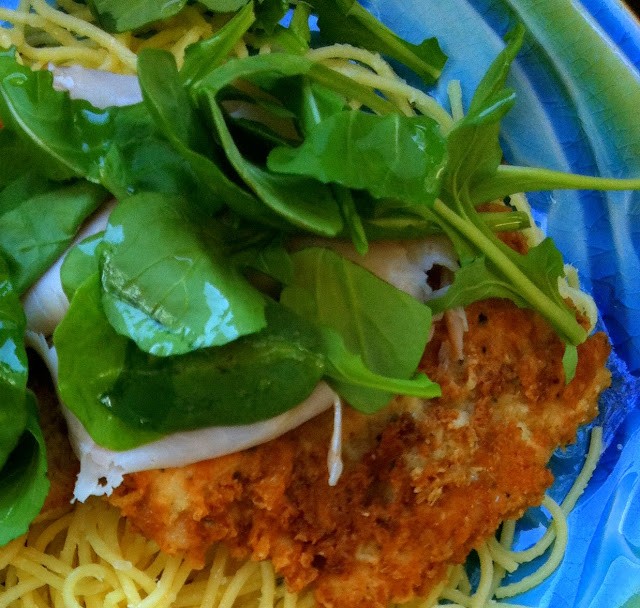 A close up of chicken bellagio and arugula leaves
