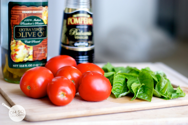 A side shot of tomatoes and basil for making an easy bruschetta bar