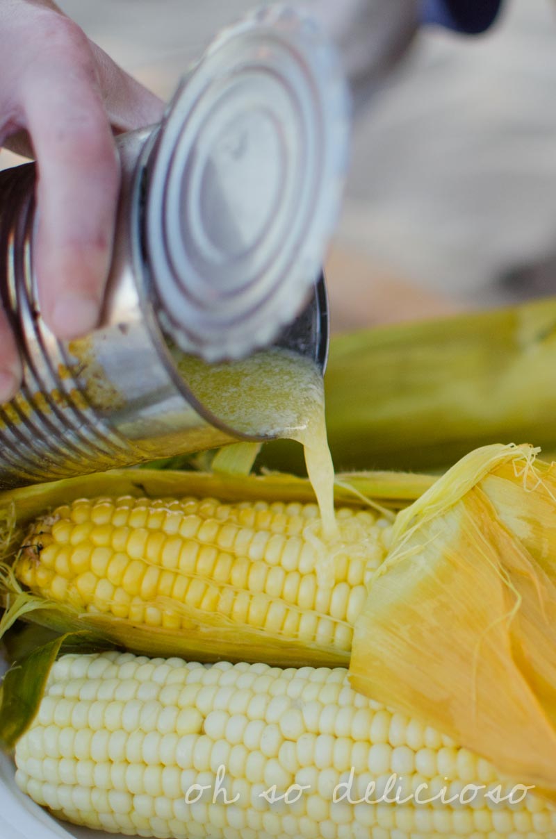 Pouring butter over corn on the cob