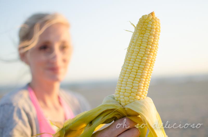 A woman holding corn on the cob
